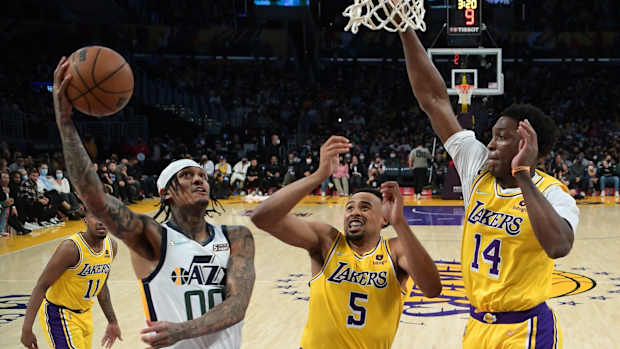 Los Angeles Lakers guard Talen Horton-Tucker (5) and Los Angeles Lakers forward Stanley Johnson (14) defend Utah Jazz guard Jordan Clarkson (00) as he goes to the basket in the second half of the game at Crypto.com Arena.